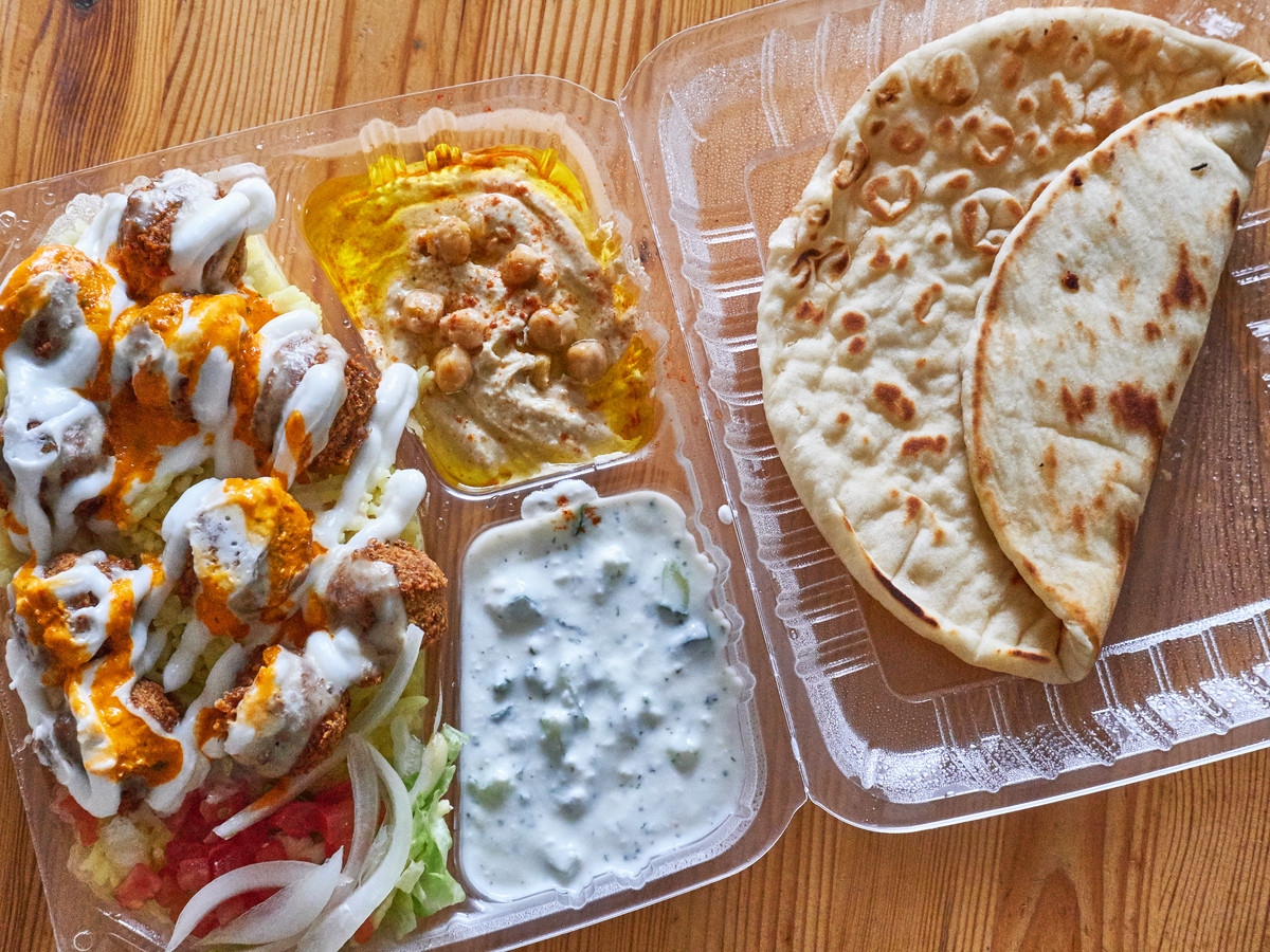 A takeout plate of falafels, hummus, and pita bread from Gyro Kingdom in the Yard at Montavilla
