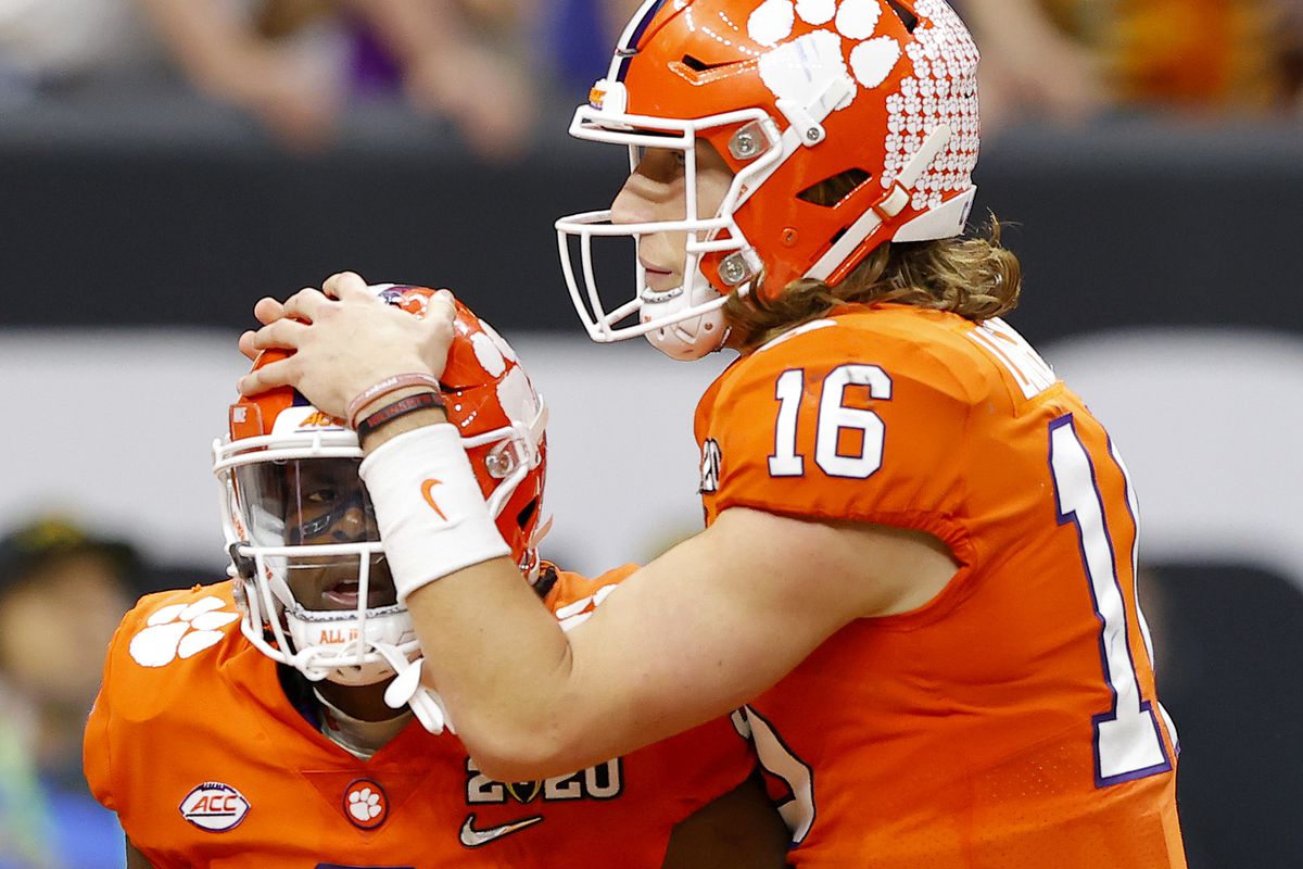 Trevor Lawrence #16 of the Clemson Tigers celebrates with Travis Etienne #9 of the Clemson Tigers after a touchdown in the College Football Playoff National Championship game at Mercedes Benz Superdome on January 13, 2020 in New Orleans, Louisiana.