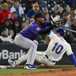  Jarred Kelenic #10 of the Seattle Mariners steals 2nd base, then advances to 3rd on a throwing error by Brian Serven #6 of the Colorado Rockies at T-Mobile Park on April 16, 2023 in Seattle, Washington.