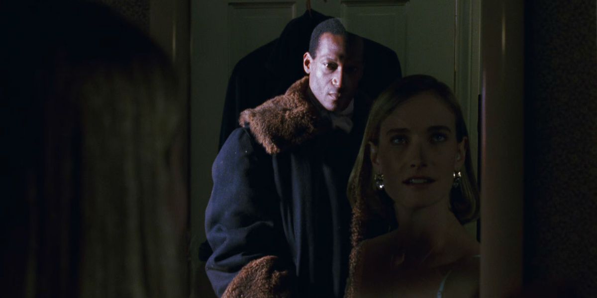 Candyman appears in a mirror behind a woman