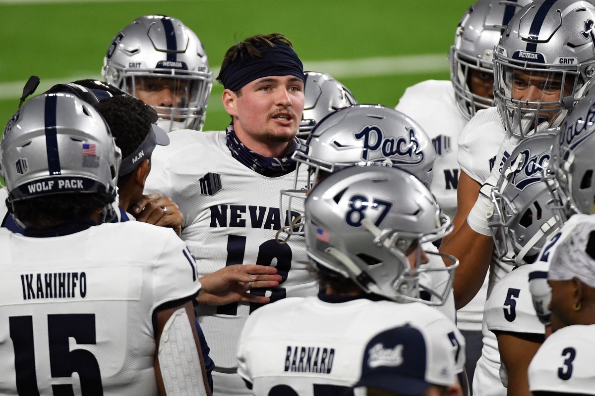 Quarterback Carson Strong #12 of the Nevada Wolf Pack stands with teammates during a timeout in the first half of their game against the UNLV Rebels at Allegiant Stadium on October 31, 2020 in Las Vegas, Nevada. The Wolf Pack defeated the Rebels 37-19.
