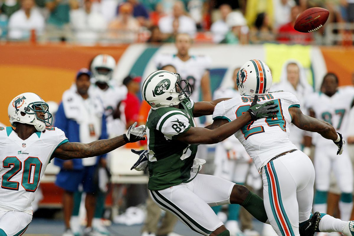Sept 23, 2012; Miami Gardens, FL, USA;  Miami Dolphins cornerback Sean Smith (24) breaks up a pass intended for New York Jets wide receiver Stephen Hill (84) in the first quarter at Sun Life Stadium. Mandatory Credit: Robert Mayer-US PRESSWIRE