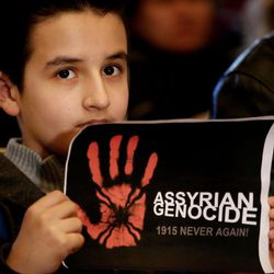 An Assyrian boy holds a poster during a sit-in for abducted Christians in Syria and Iraq, at a church in Sabtiyesh area east Beirut, Lebanon, Thursday, Feb. 26, 2015. Islamic State militants snatched more hostages from homes in northeastern Syria over the past three days, bringing the total number of Christians abducted to over 220 in the one the largest hostage-takings by the extremist group, activists said Thursday. 