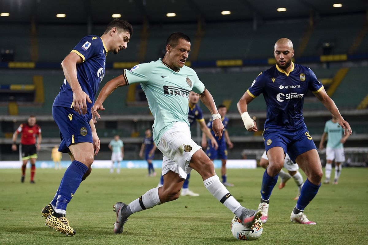 Alexis Sanchez (C) of FC Internazionale is challenged by...