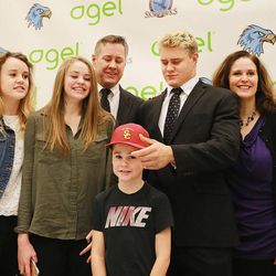 Salem Hills' Porter Gustin stands with his family after his announcement Tuesday, Feb. 3, 2015, that he will be playing for the USC Trojans, during an event at the school with family, friends and coaches around.