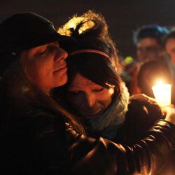 This Saturday, Jan. 3, 2015 photo shows Tiffany Neri, left, embracing Cassie Thompson during a group hug at the end of the vigil to remember the life of Leelah Alcorn, a 17 year-old transgender girl who committed suicide, in Kings Mills, Ohio.  In what's believed to be her final message, Alcorn implored: "My death needs to mean something." It has, at least making her a poignant new face for the transgender movement and those struggling to fit in. 