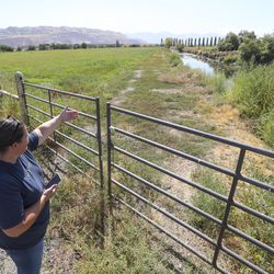 Heather Limon, owner of Cross E Ranch, shows where housing is going to be built next to her property in North Salt Lake on Friday, Aug. 30, 2019. Limon is a generational farmer who wants to celebrate and share the agricultural lifestyle with future generations. She is supportive of the annexation to help bring future stability to her own property, but also supportive of allowing property owners to do what they want with their land.