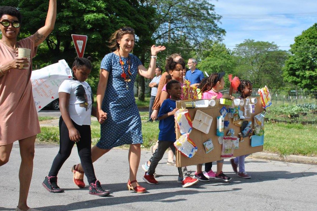 Teacher Kelly Rickert of the James and Grace Lee Boggs school, leads her students, wearing an incinerator costume, in a parade as part of lesson on trash and pollution.