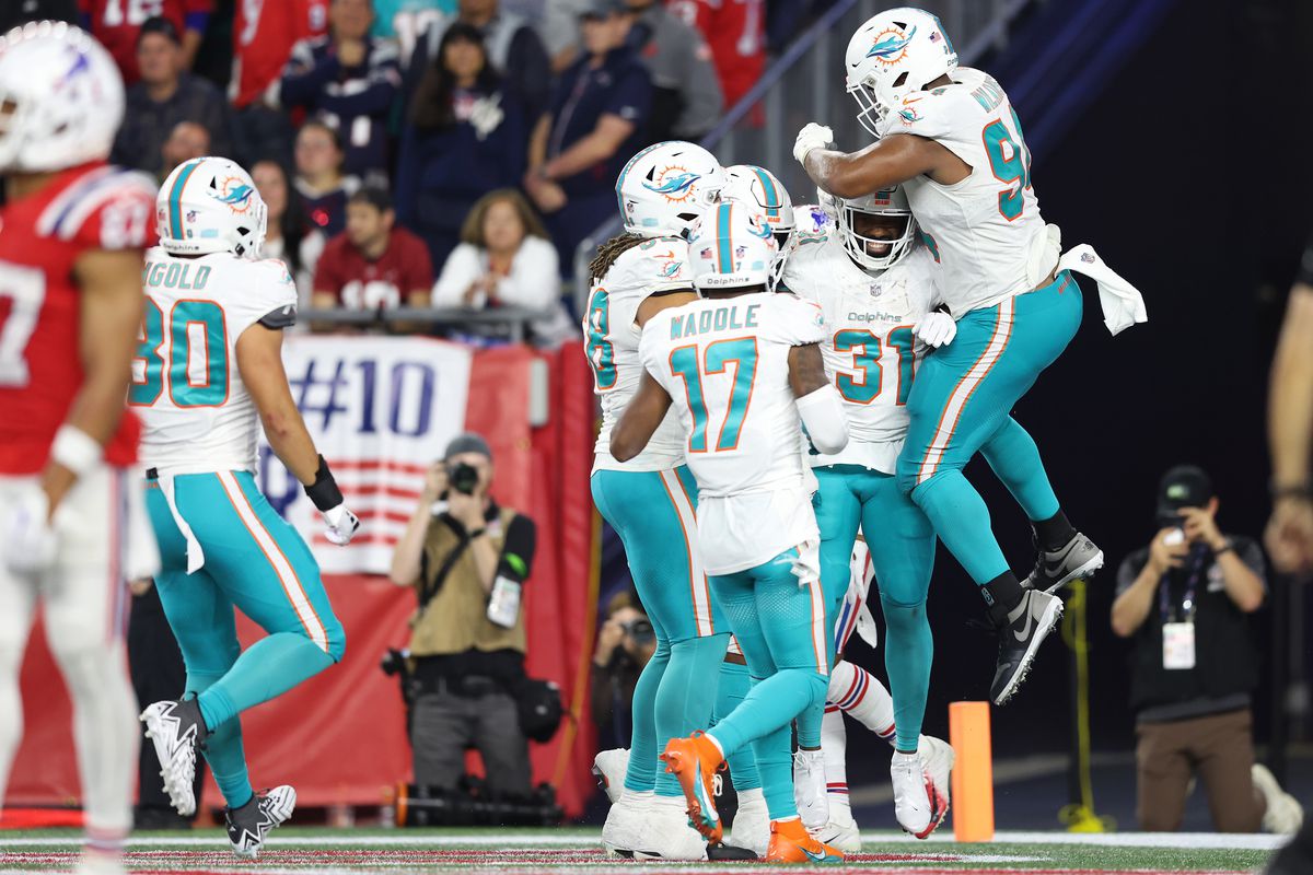 Raheem Mostert #31 of the Miami Dolphins celebrates with teammates after running the ball for a touchdown during the fourth quarter against the New England Patriots at Gillette Stadium on September 17, 2023 in Foxborough, Massachusetts.