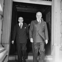 U.S. President Harry S. Truman smiles as he steps along the corridor of the Capitol building approaching the House Chamber for his address to a joint session in Congress in Washington, D.C., March 12, 1947. Accompanying the president at left is Sgt.-at-Arms Edward F. McGinnis. 