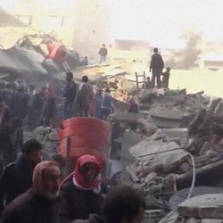 In this image made from Tuesday, Jan. 7, 2014, amateur video released by Ugarit News, which has been authenticated based on its contents and other AP reporting, people gather to help clear rubble in Douma, Syria. In the town close to the Syrian capital of Damascus, several people were killed and wounded after a government airstrike targeted a house on Tuesday, reported the Observatory and another activist group, the Local Coordination Committees.