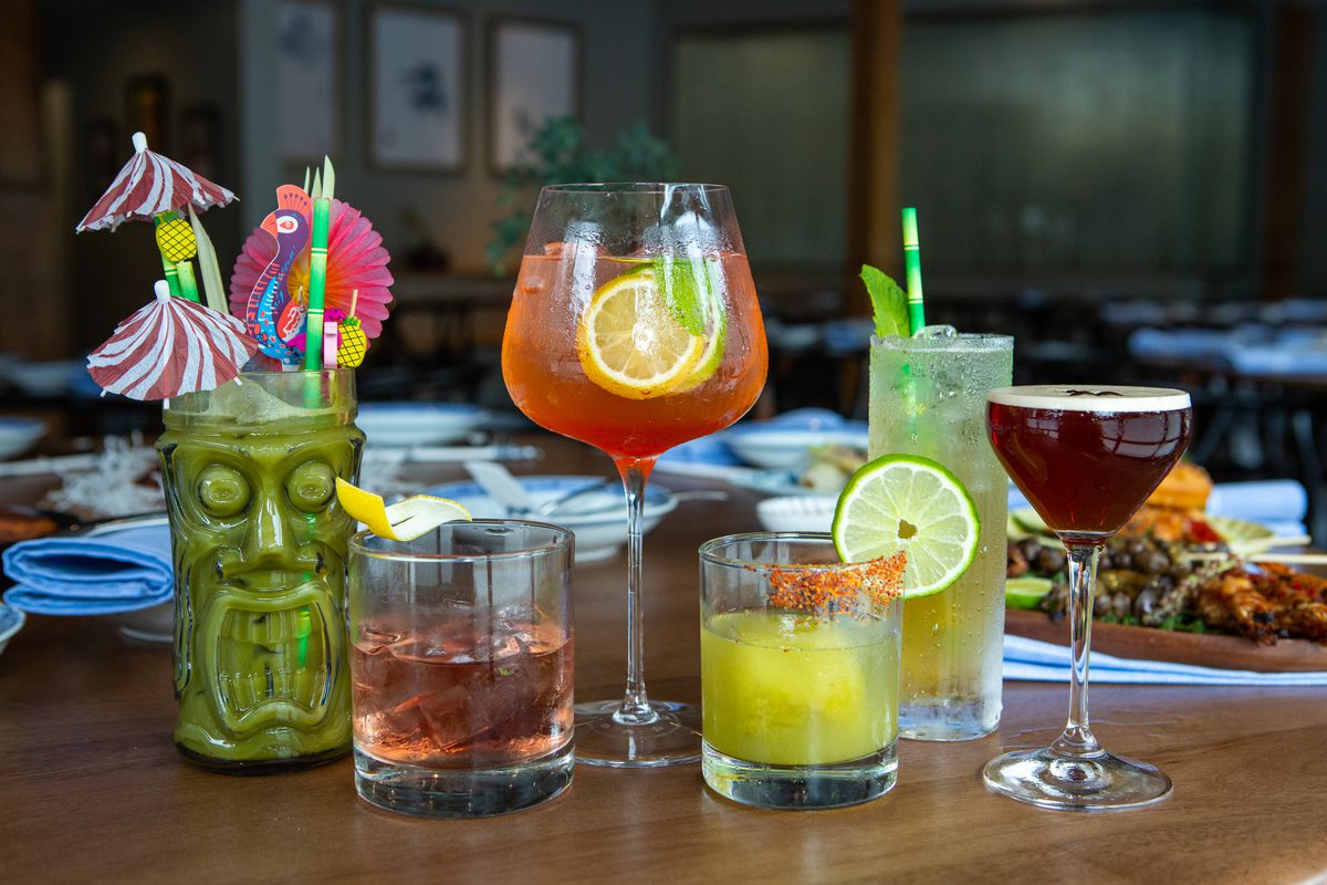Several cocktail glasses with different drinks.