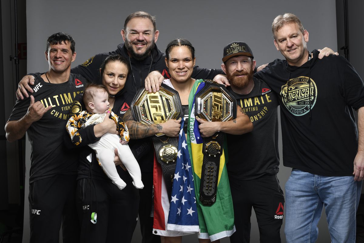 Amanda Nunes poses with coaches, family and ATT owner Dan Lambert after her victory at UFC 259.