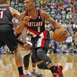 Portland Trail Blazers point guard Damian Lillard (0) drives as the Utah Jazz defeat the Portland Trailblazers 112-102 in NBA basketball April 1 in Salt Lake City.