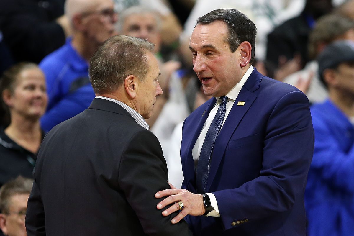 Michigan State Spartans head coach Tom Izzo and Duke Blue Devils head coach Mike Krzyzewski shake hands at mid court during the second half of a game at Breslin Center.