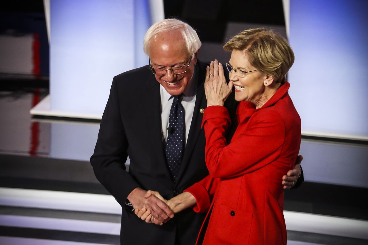 Democratic presidential candidates Sen. Bernie Sanders (I-VT) and Sen. Elizabeth Warren (D-MA) greet each other at the start of the Democratic Presidential Debate on July 30, 2019.