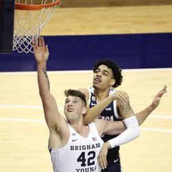 Brigham Young Cougars center Richard Harward (42) reaches for the rebound in front of Gonzaga Bulldogs guard Julian Strawther (0) during a basketball game at the Marriott Center in Provo on Monday, Feb. 8, 2021. BYU lost 71-82.