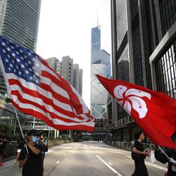 Protesters wave the Hong Kong and United States flag during a march in Hong Kong on Sunday, July 21, 2019. Tens of thousands of Hong Kong protesters marched from a public park to call for an independent investigation into police tactics. (AP Photo/Vincent Yu)