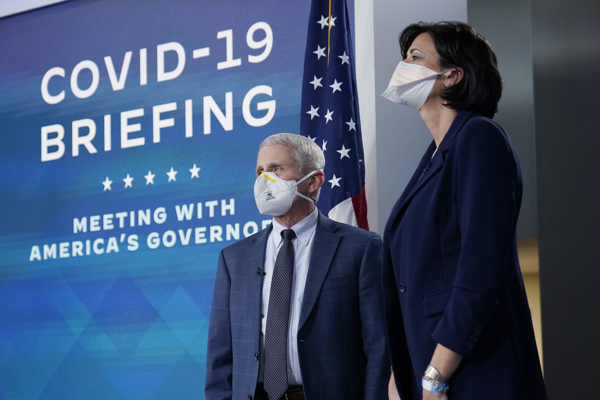 Anthony Fauci and Rachel Walensky stand onstage beside a wall that reads, “Covid-19 briefing, meeting with America’s governors.”