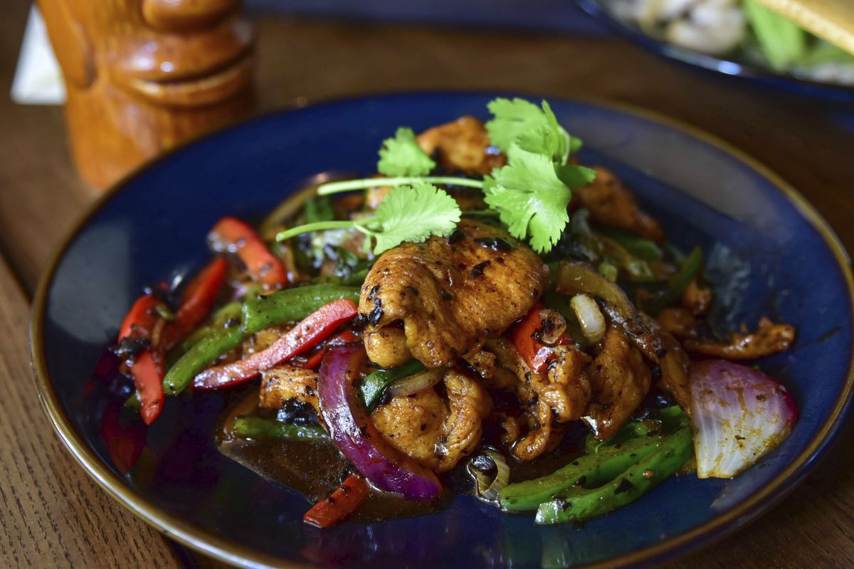A dish with chicken, onions, peppers, and a fermented Black bean sauce.