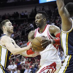 Houston Rockets' Dwight Howard (12) is double-teamed by Utah Jazz's Gordon Hayward (20) and Derrick Favors (15) in the first half of an NBA basketball game Wednesday, March 23, 2016, in Houston. 