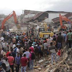 Rescuers use excavators to search for victims under the rubble of collapsed buildings after an earthquake in Pidie Jaya, Aceh province, Indonesia, Wednesday, Dec. 7, 2016. A strong earthquake rocked Indonesia's Aceh province early on Wednesday, killing a large number of people and sparking a frantic rescue effort in the rubble of dozens of collapsed and damaged buildings. 