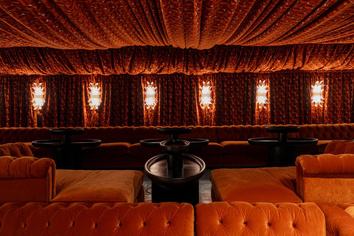 A moody lounge covered entirely in plush fabric.
