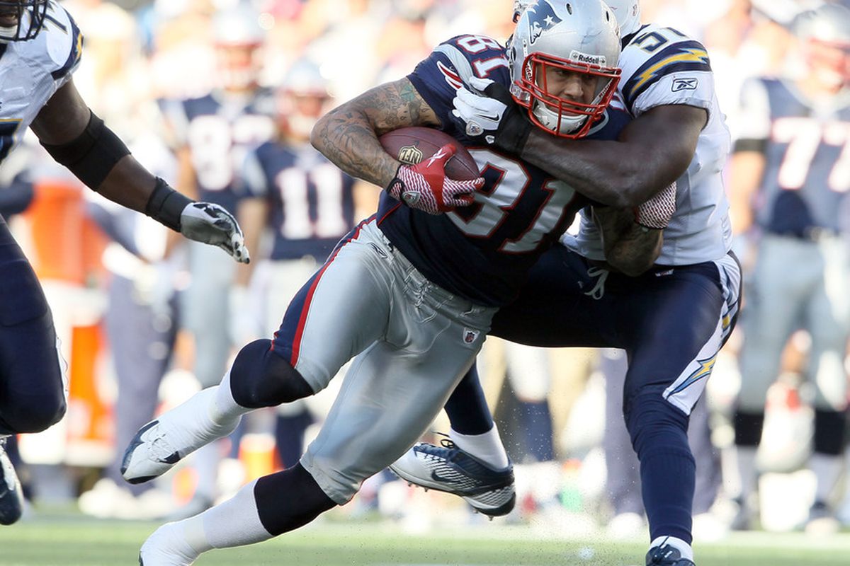 FOXBORO, MA - SEPTEMBER 18:   Aaron Hernandez #81 of the New England Patriots is tackled by Takeo Spikes #51 of the San Diego Chargers on September 18, 2011 at Gillette Stadium in Foxboro, Massachusetts.  (Photo by Elsa/Getty Images)