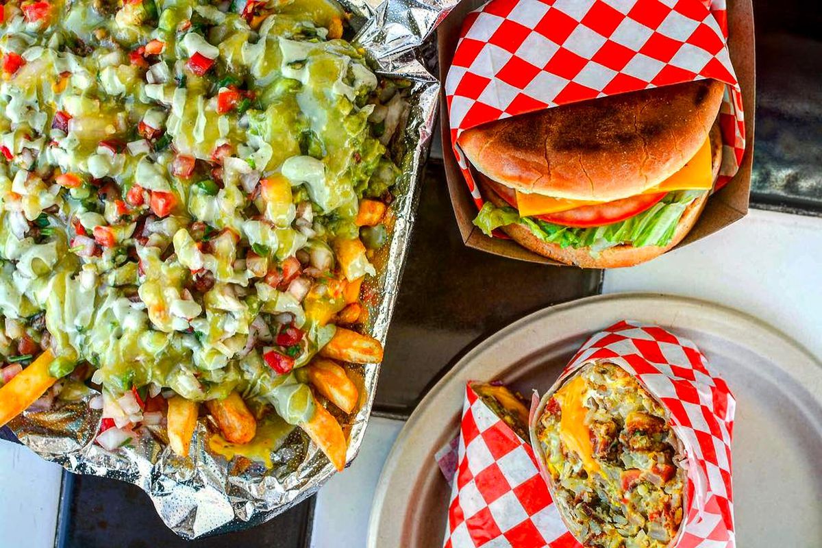 Loaded fries with guacamole, a burger, and breakfast burrito.