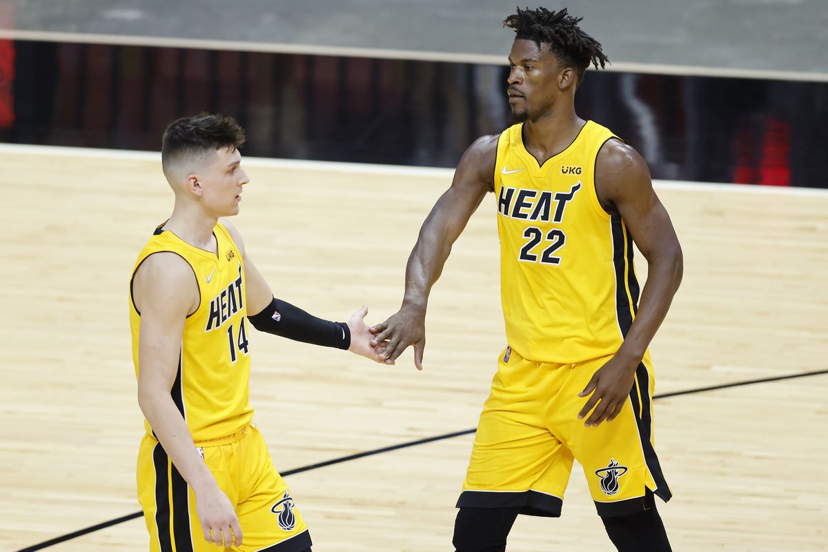 Tyler Herro of the Miami Heat celebrates with Jimmy Butler against the Cleveland Cavaliers during the third quarter at American Airlines Arena on March 16, 2021 in Miami, Florida.