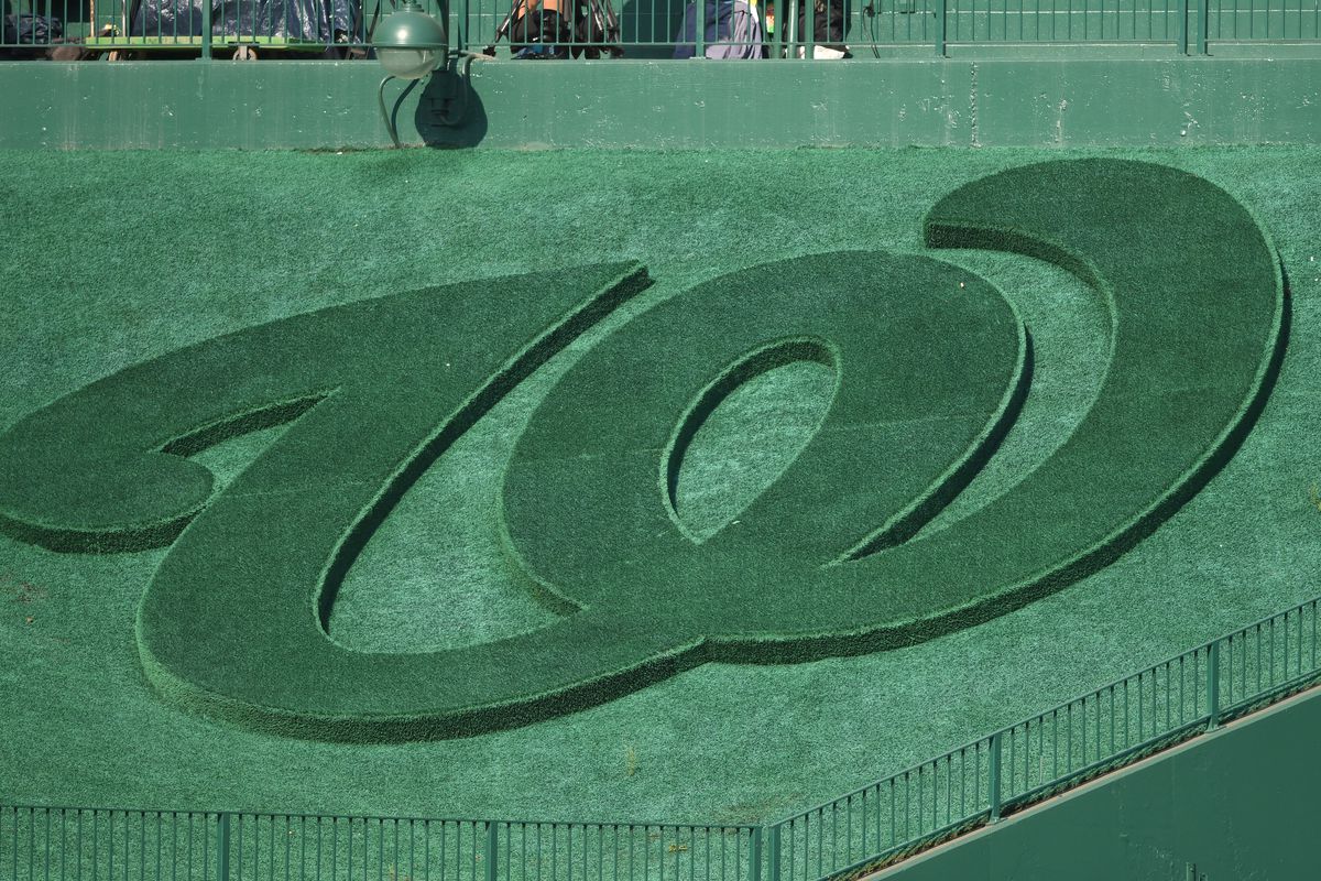 The Washington Nationals logo cut into grass above center field during a baseball game against the Miami Marlins at Nationals Park on September 18, 2022 in Washington, DC.