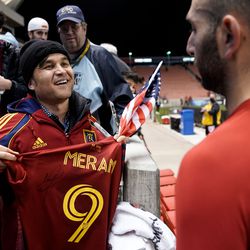 Azim Kakaie, left, looks at Real Salt Lake forward Justin Meram while holding a signed jersey after a soccer match against Portland at Rio Tinto Stadium in Sandy on Wednesday, Nov. 3, 2021.