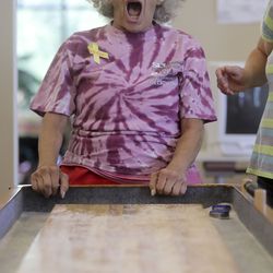 Shirley Draper watches as her puck goes over the edge of the table while competing in table shuffleboard during the ninth annual Salt Lake County Senior Wellness Decathlon at the Magna Kennecott Senior Center in Magna on Tuesday, Sept. 17, 2019.