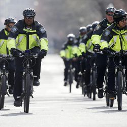 Boston police on bicycles patrol on Commonwealth Avenue following the explosions at the finish line of the Boston Marathon in Boston, Monday, April 15, 2013. Two bombs exploded at the Boston Marathon finish line Monday killing two people and injuring dozens. 