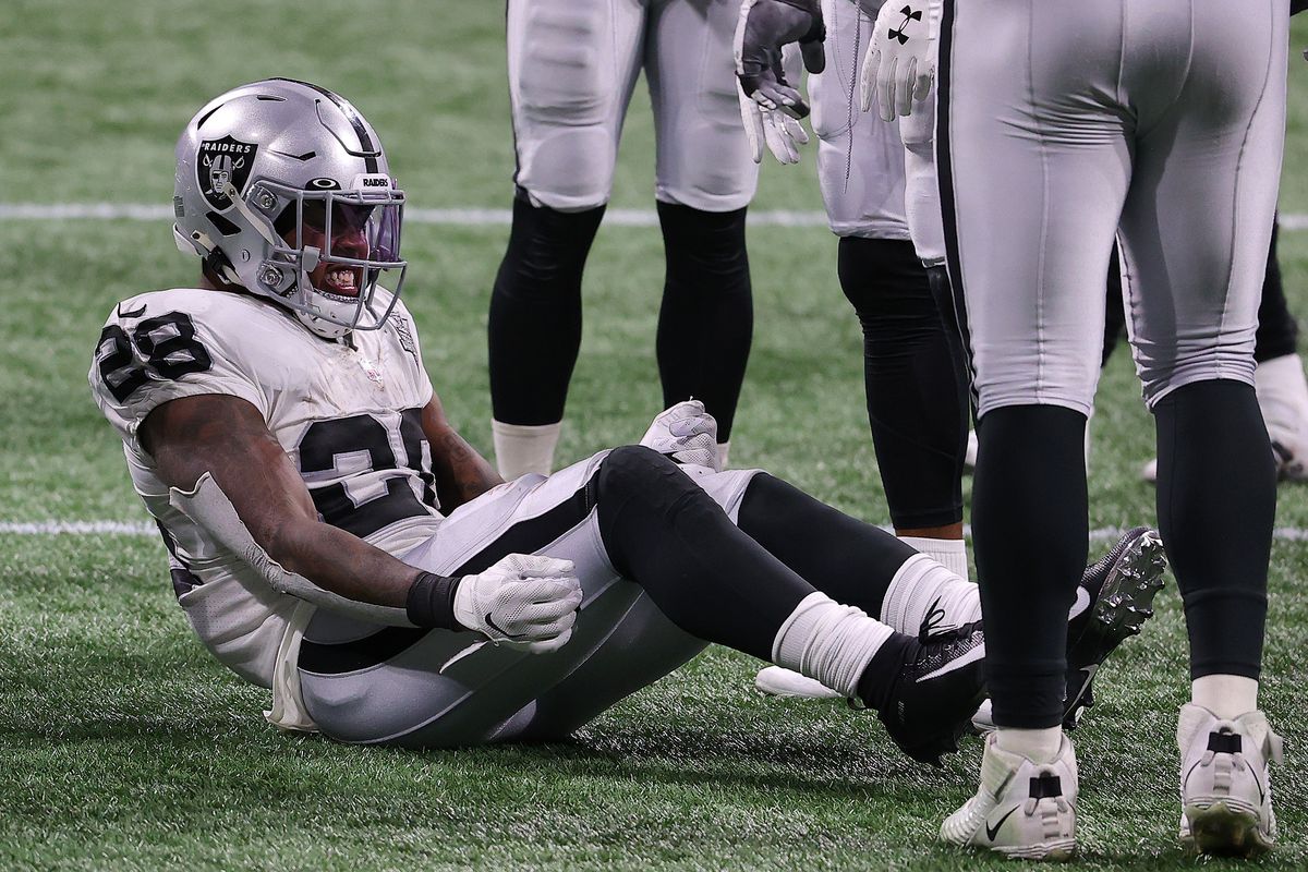 Josh Jacobs #28 of the Las Vegas Raiders reacts after being injured on a play against the Atlanta Falcons during their NFL game at Mercedes-Benz Stadium on November 29, 2020 in Atlanta, Georgia.