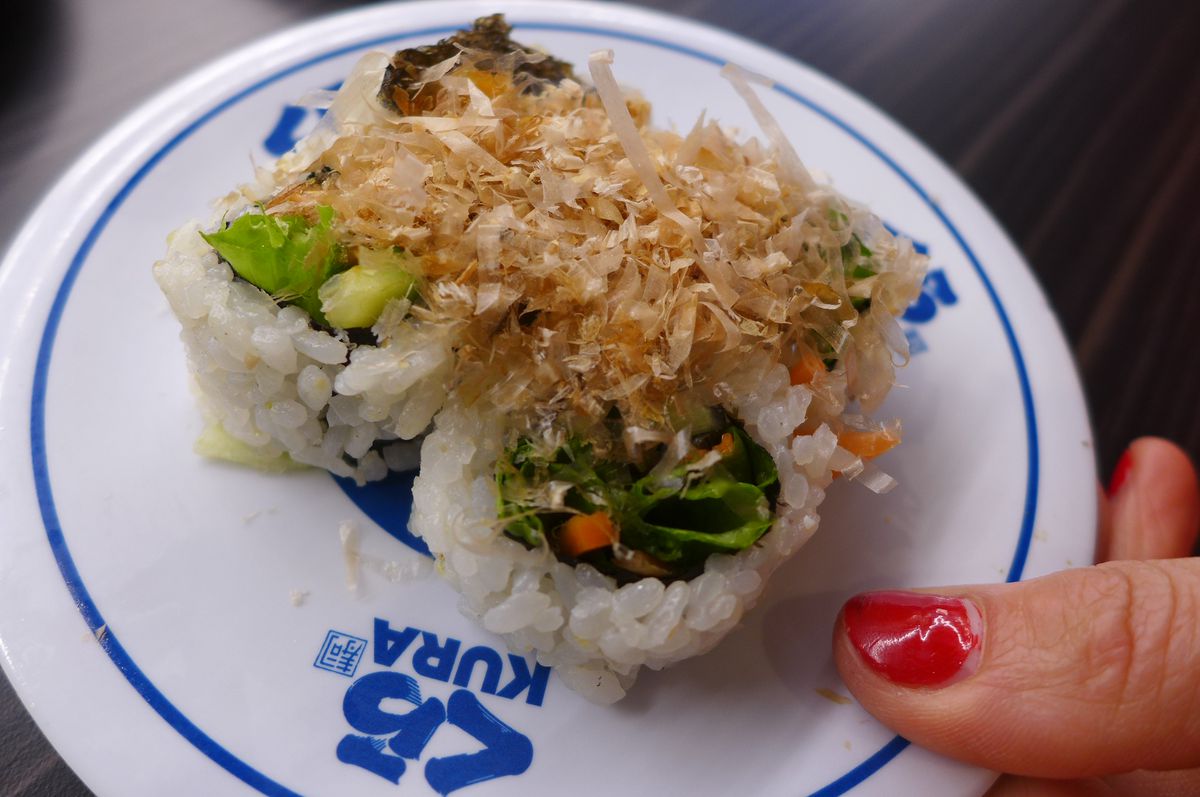A makki roll with bonito flakes on top.