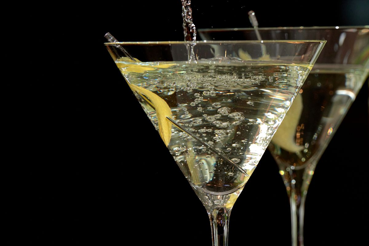 A clear martini being poured into a glass