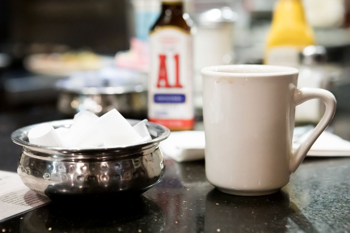 A mug and a bowl of creamer.