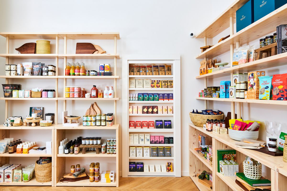 A store with blonde wood shelves filled with food products.