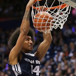 Utah State Aggies forward Jalen Moore (14) dunks the ball as BYU and Utah State play at the Marriott Center in Provo Wednesday, Dec. 9, 2015.
