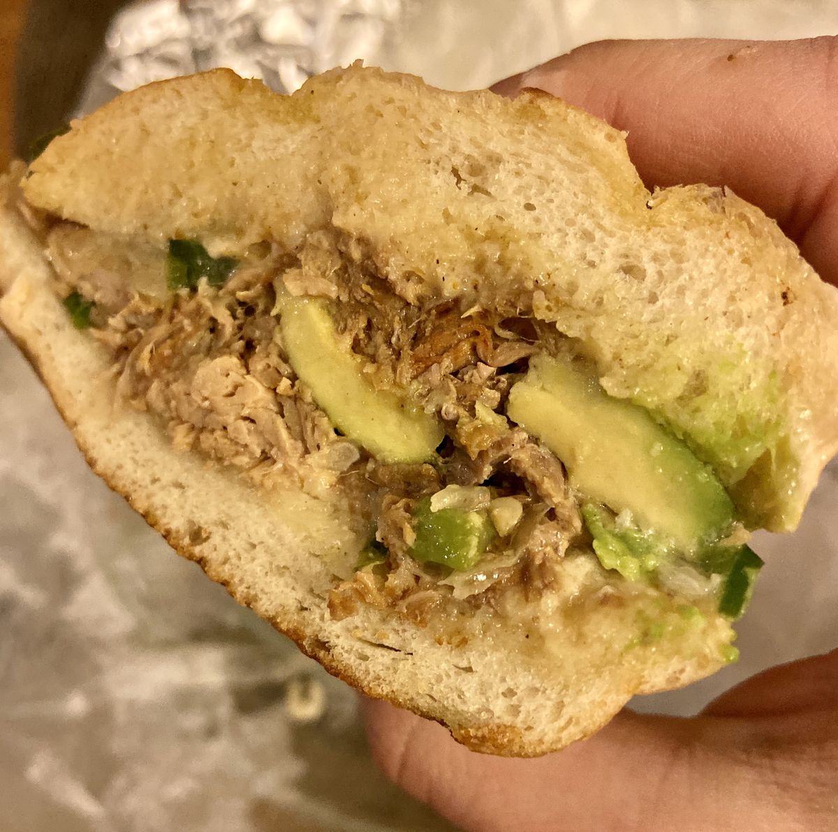 A Costa Rican sandwich of pulled pork, garlic aioli, jalapenos, caramelized onions, and avocado.