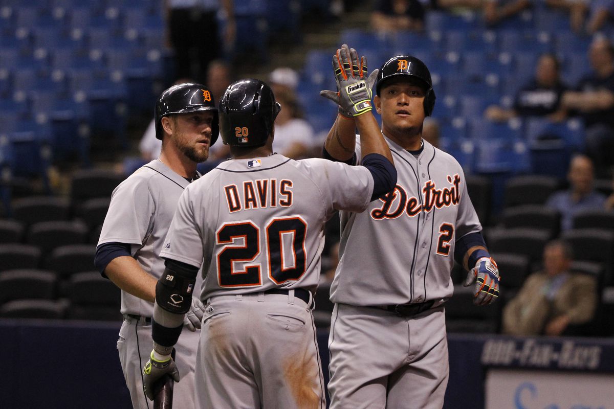 Rajai Davis congratulates Miguel Cabrera after he scored a run during the eleventh inning against the Rays on August 19