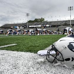 The Brigham Young Cougars warm up before the start of an NCAA football game at The Glass Bowl in Toledo, Ohio on Saturday, Sept. 28, 2019.