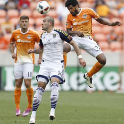 Houston Dynamo midfielder Sheanon Williams (22) goes up for a header against Real Salt Lake forward Yura Movsisyan (14) during the second half of a soccer game at BBVA Compass Stadium, Sunday, May 15, 2016, in Houston.  Dynamo won the game 1-0. (Karen Warren/Houston Chronicle via AP) 