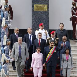 Venezuela's President Nicolas Maduro, center, flanked by his wife Cilia Flores, left, and Constitutional Assembly President Delay Rodriguez, arrive to the National Assembly building to attend a special session of the constitutional assembly in Caracas, Venezuela, Thursday, Aug. 10, 2017. The new constitutional assembly has declared itself as the superior body to all other governmental institutions, including the opposition-controlled congress. At top is a bust of the nation's independence hero Simon Bolivar. (AP Photo/Ariana Cubillos)