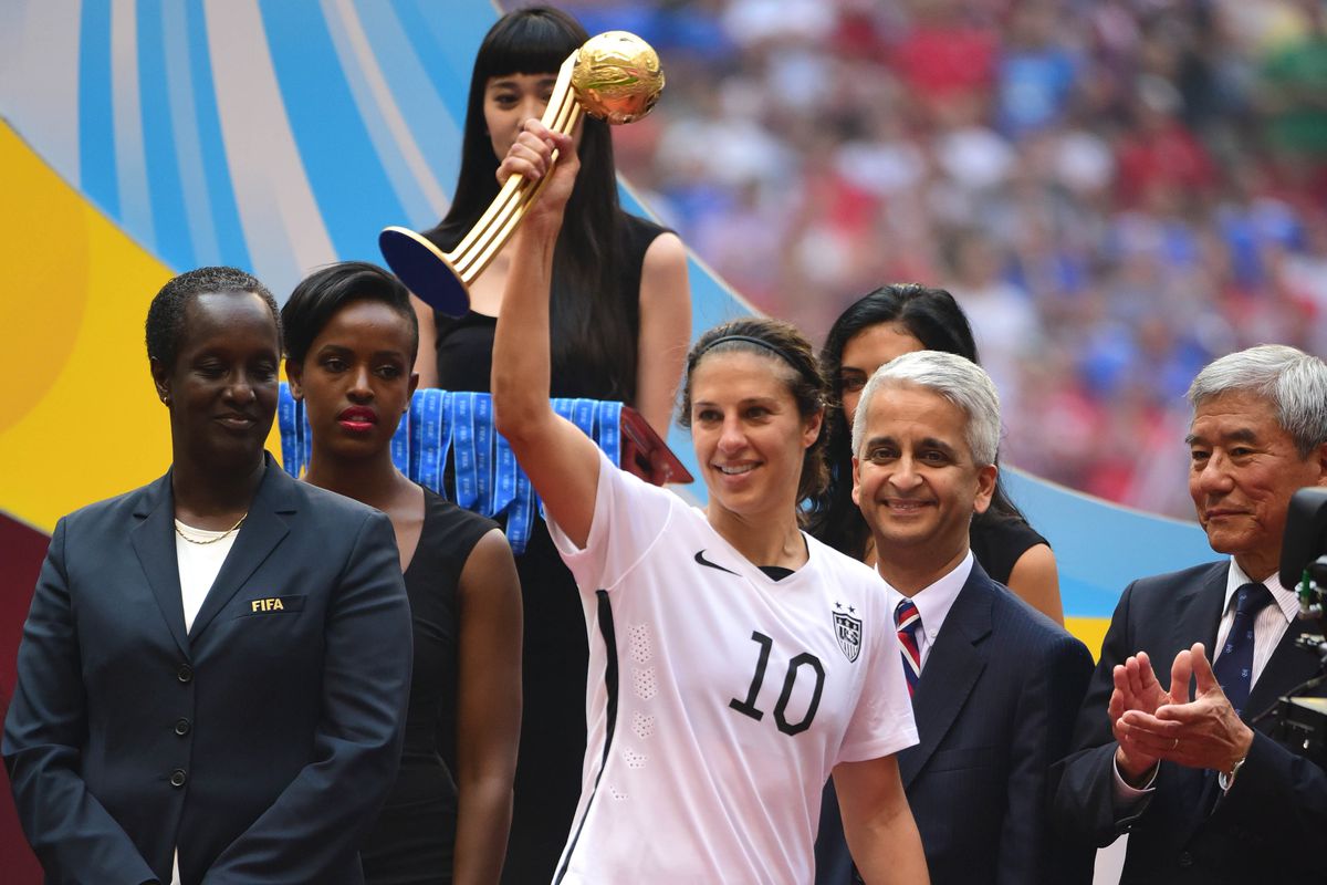Houston Dash's Carli Lloyd raises the 2015 Golden Ball Trophy, awarded to the best player in the World Cup. 
