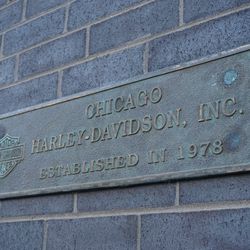 Vintage plaque outside the still unopened Harley-Davidson store, at Addison and Sheffield