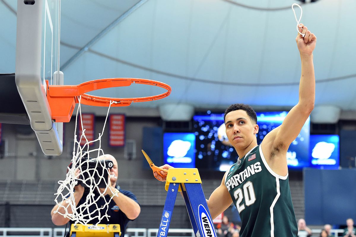 Travis Trice cutting down the nets before heading off to the Final Four in Indianapolis 