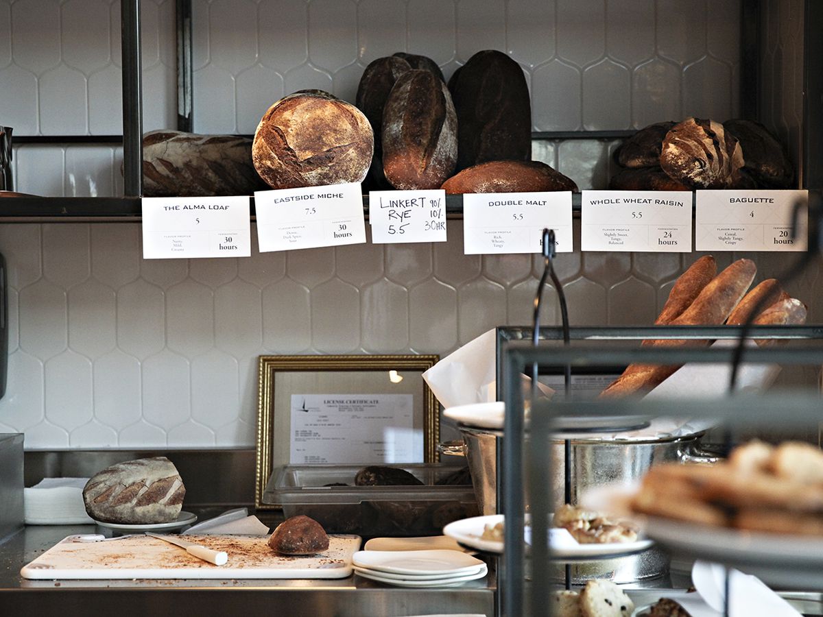 A bakery counter stocked with breads. 
