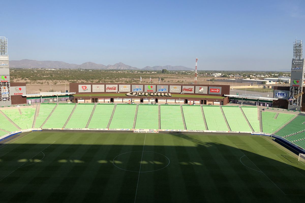 View of Estadio Corona with cerros (mountains) rising in the background.
